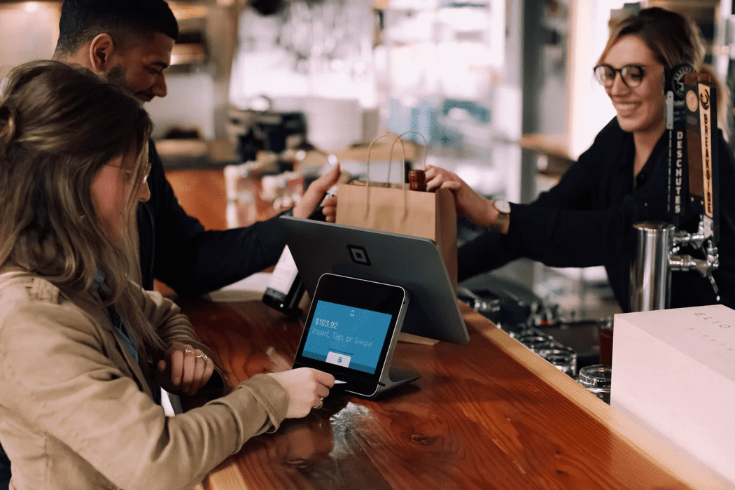 Customer using a tablet to pay for product that is connected to restaurant marketing 