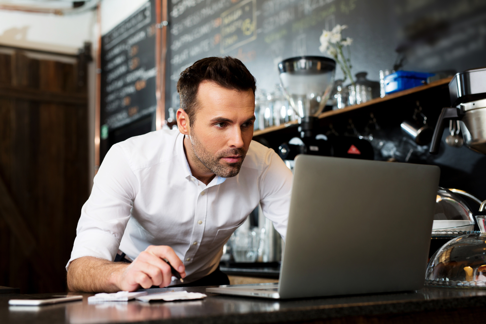 Man researching restaurant management tips