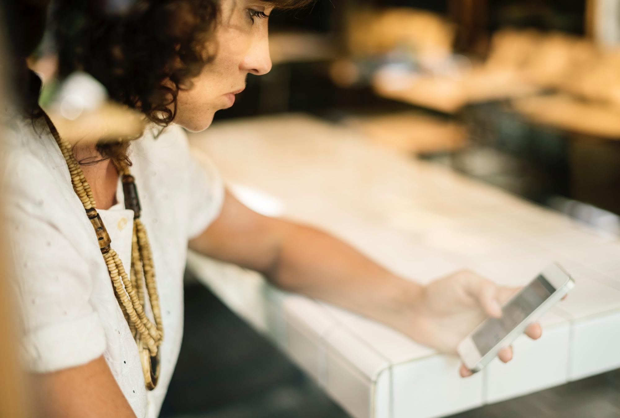 Woman reading a termination letter email on her phone