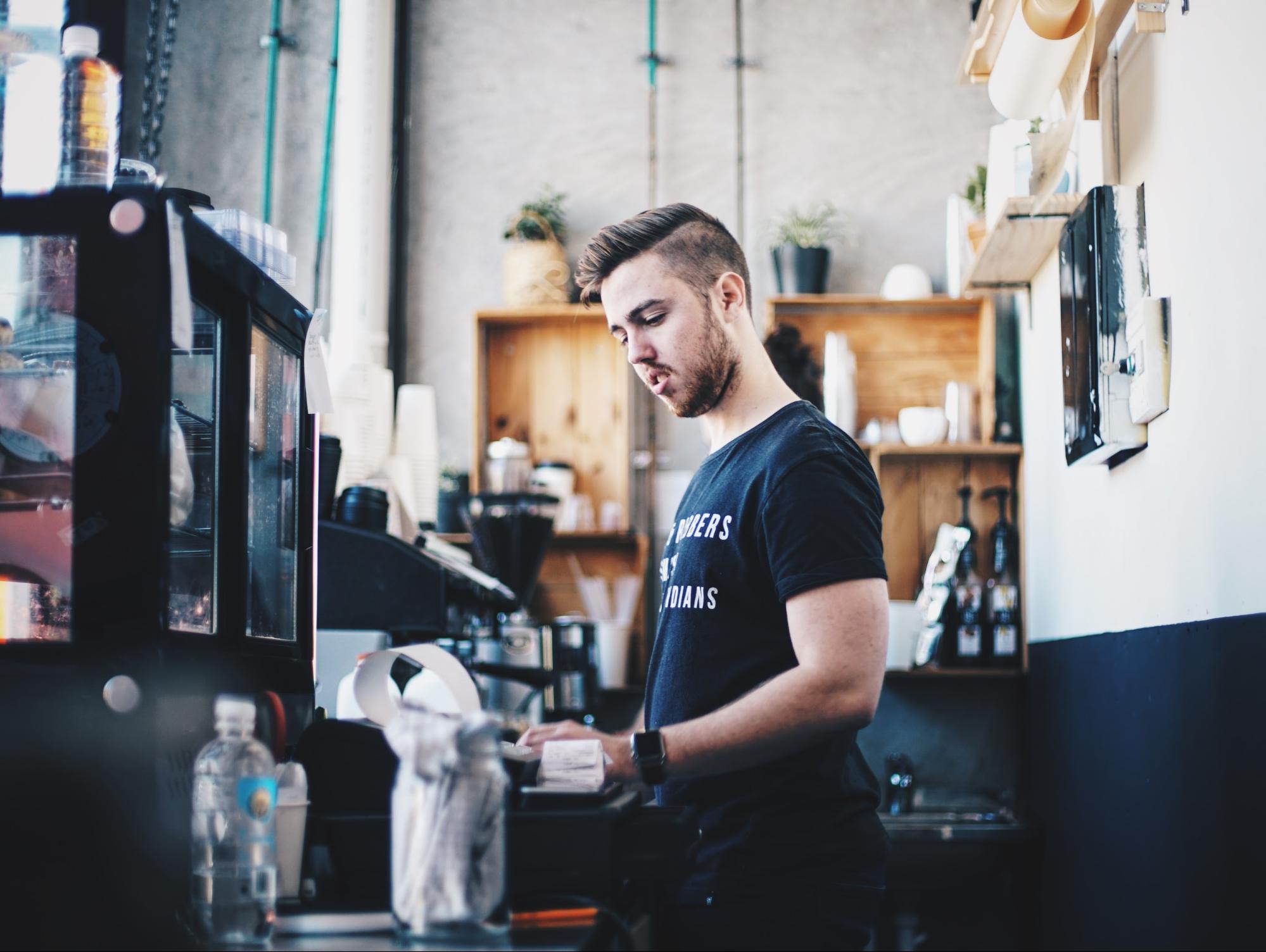 Barista working at his job