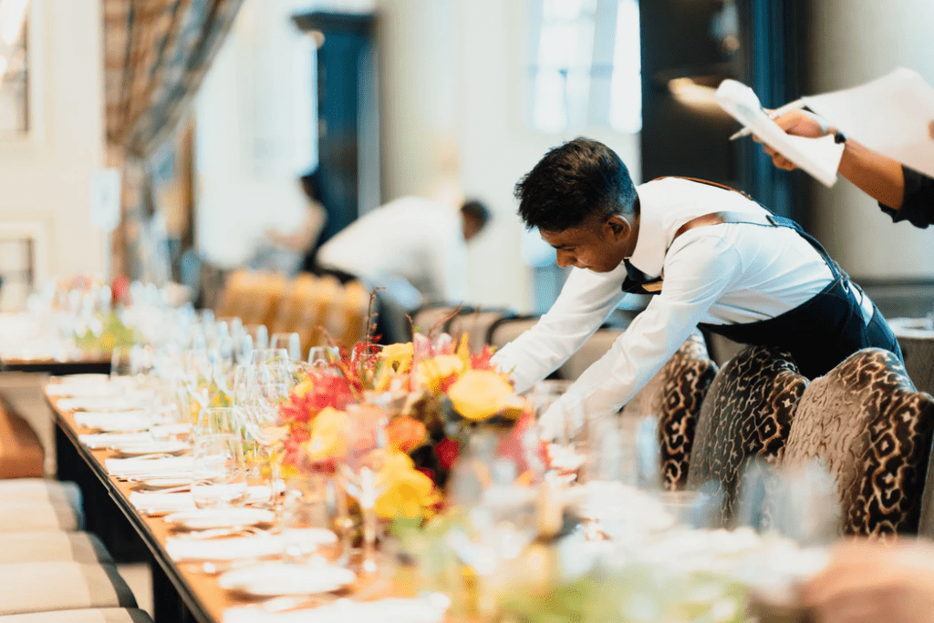 employees setting the table at a fine dining restaurant