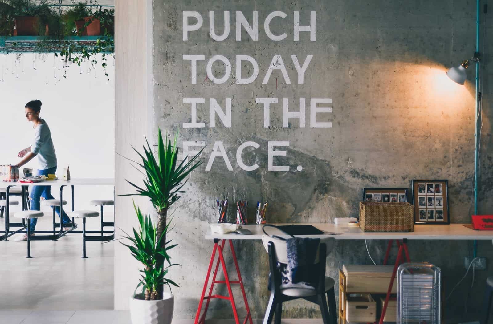 a sign reading punch today in the face in a cafe