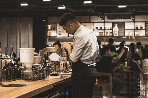 Barista pouring coffee in a coffee shop