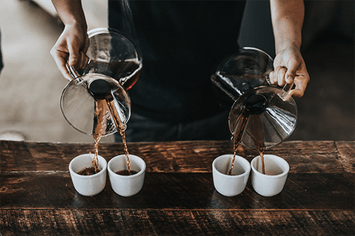 Barista pouring coffee in a coffee shop