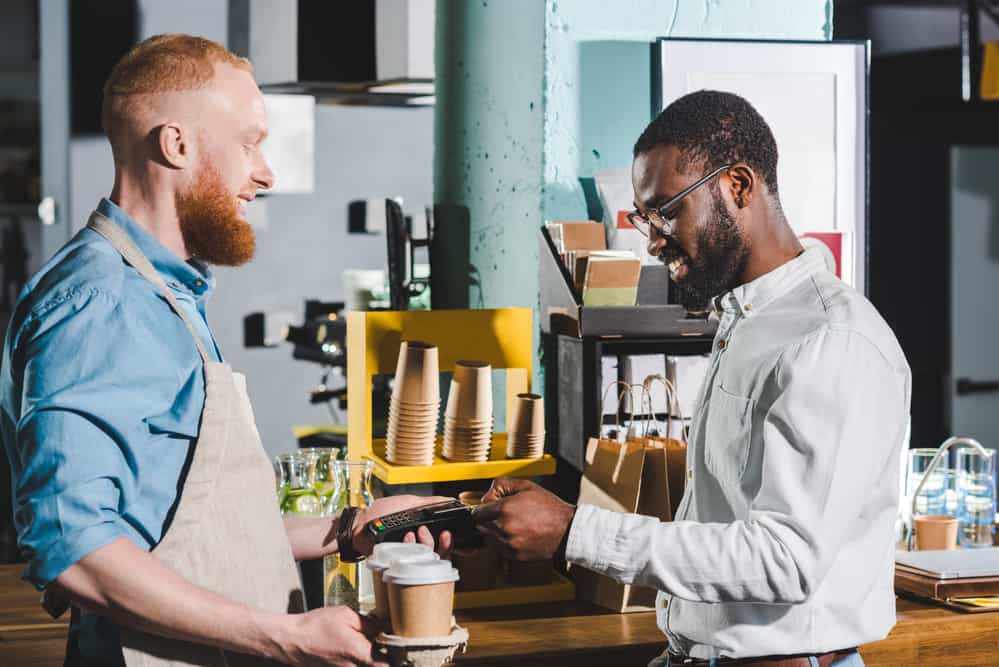 Part time employee checking a customer out