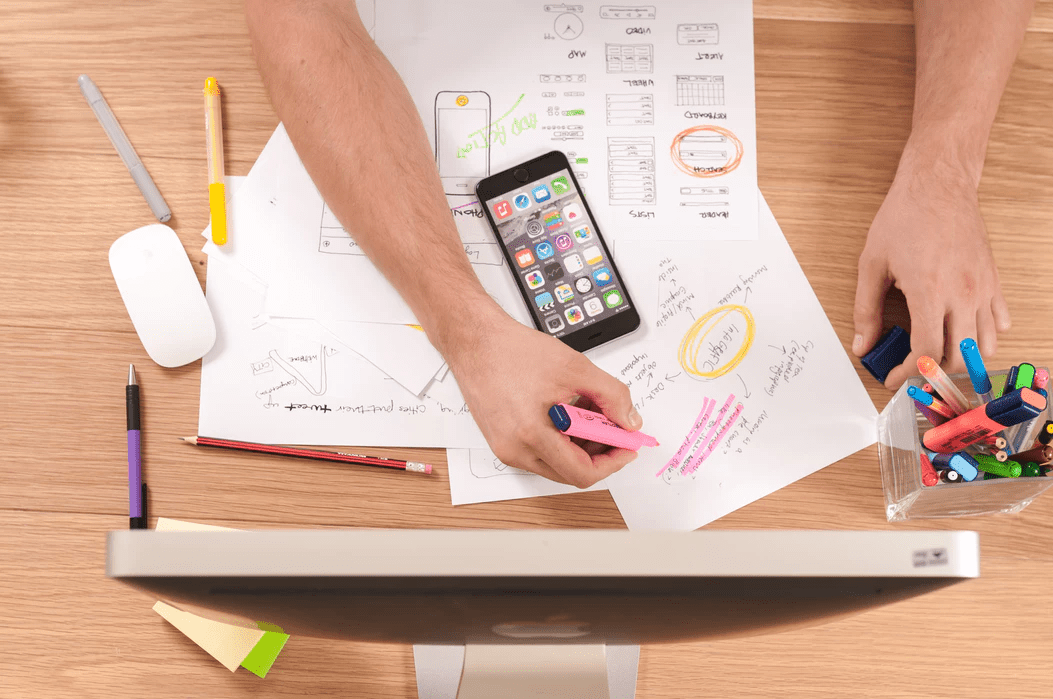 Manager at a desk using papers and a highlighter to plan on-the-job training