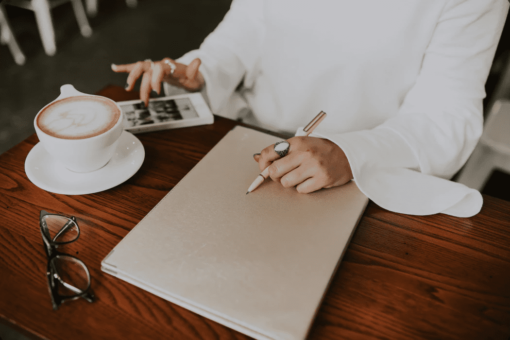 Woman at a coffee shop using social media on her phone for on-the-job training