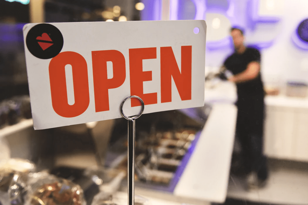 open sign in front of a small business