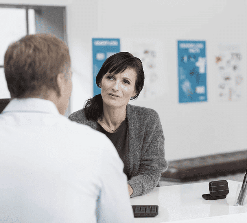 business owner sitting at a desk asking a candidate retail interview questions