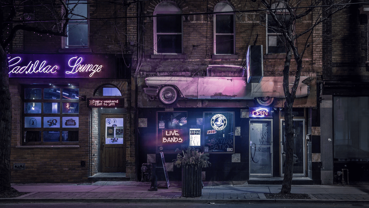 street view of the outside of a bar lit up at night