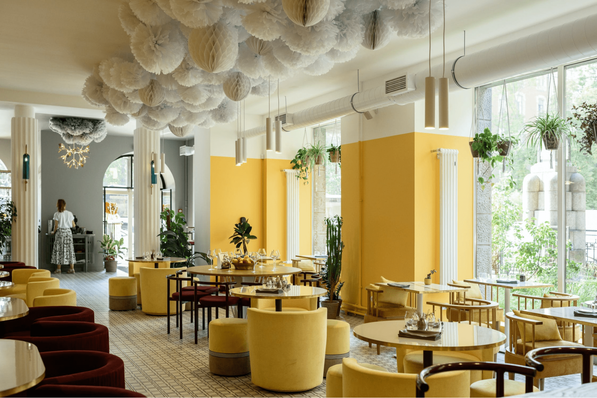 Restaurant with yellow decor and round tables