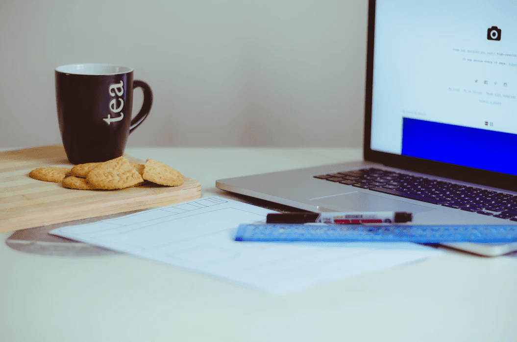 example of an organized desk with tea mug and cookies