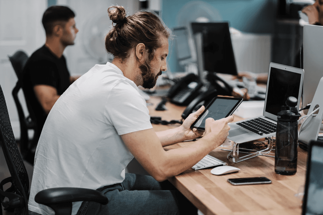 Manager working on his tablet to solve employee scheduling issues