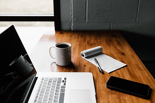 Desk with computer and coffee