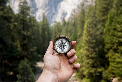person holding a compass 