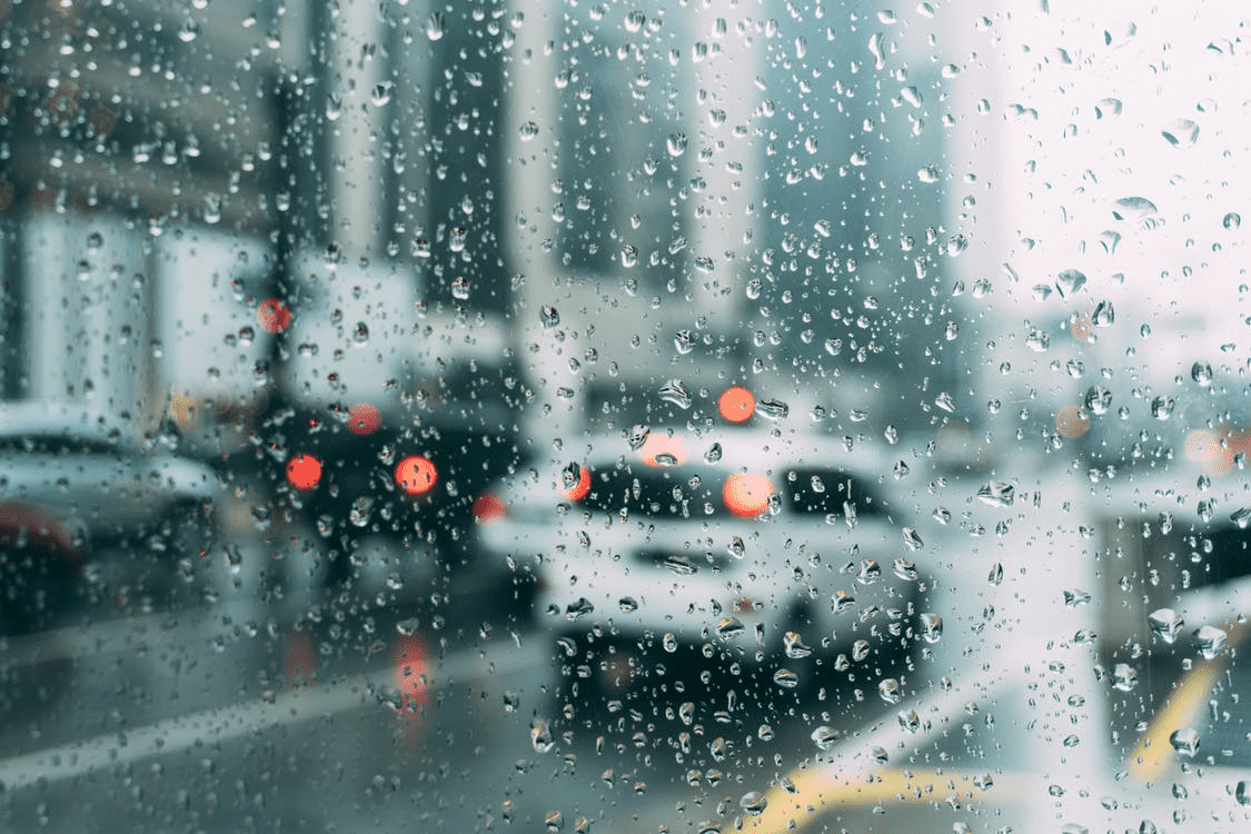 raindrops on a window looking out on cars