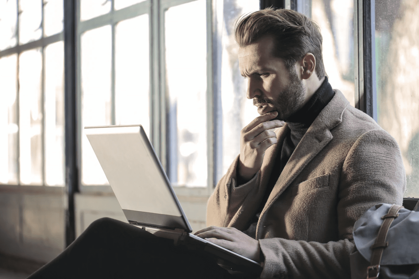 Man on laptop writing a restaurant business plan