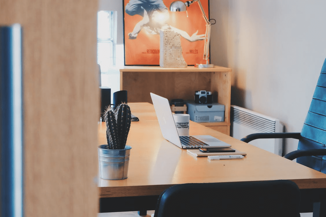 Empty office with laptop and blue chair