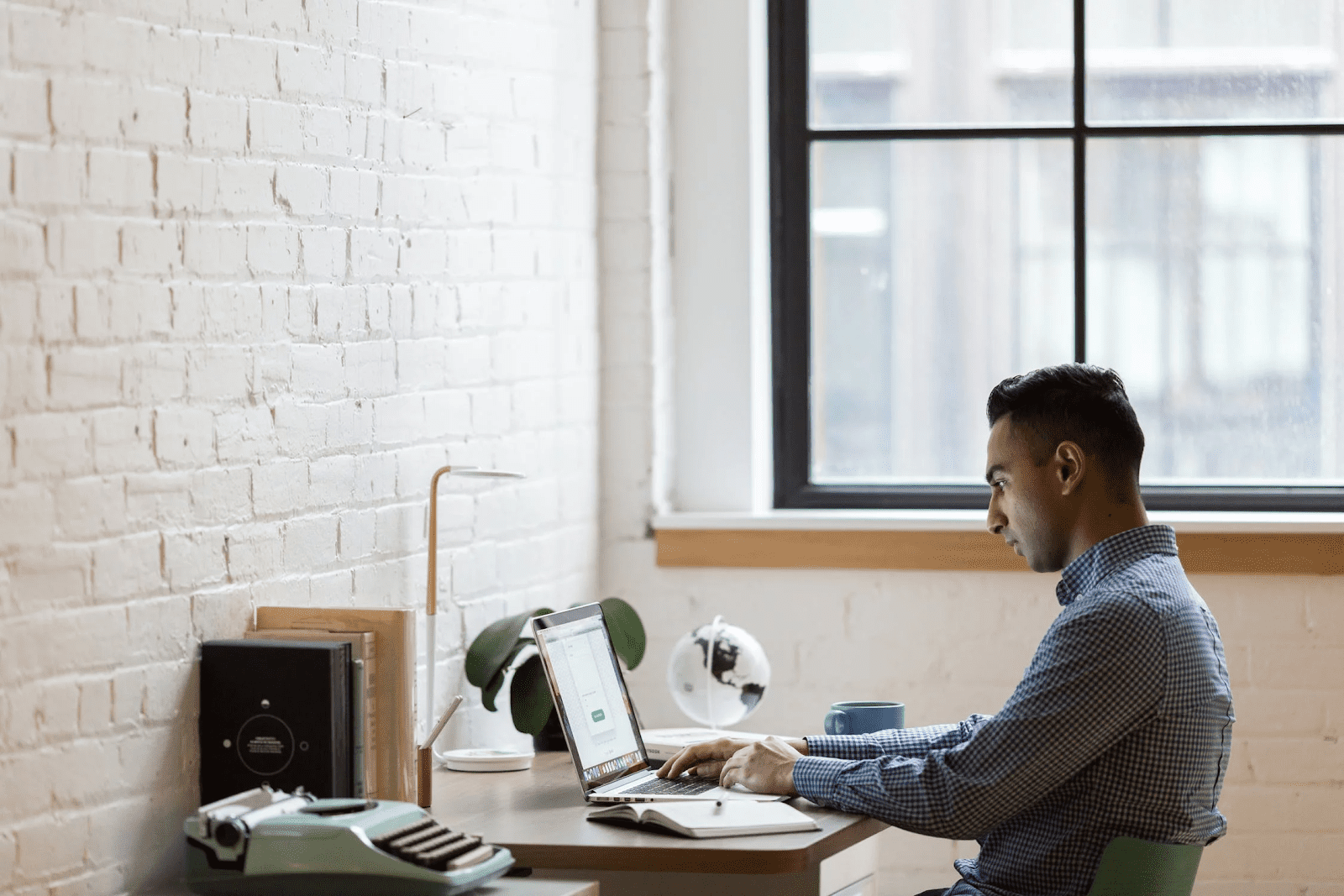 man telecommuting from his home office