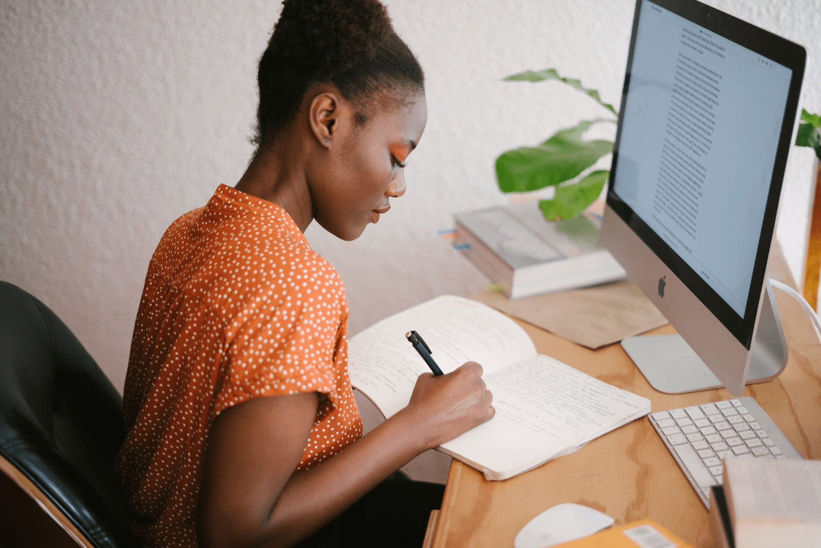 woman sitting in front of a computer writing in a workplace personality test