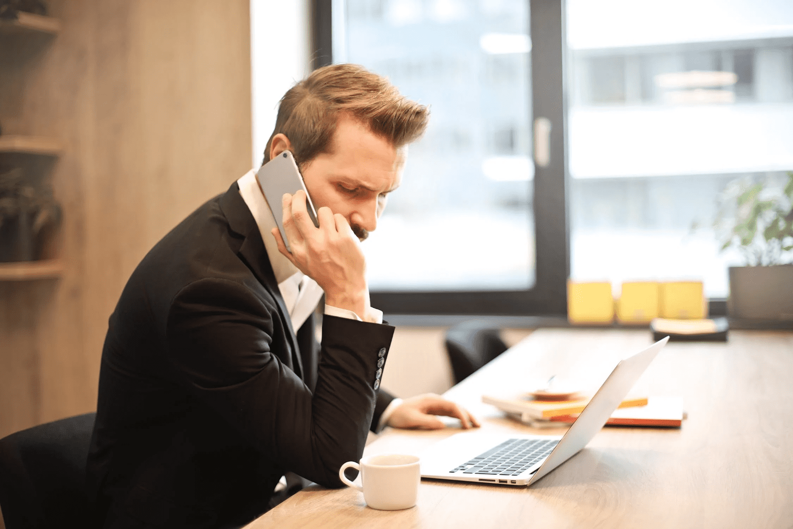 man talking on his cell phone at a conference table