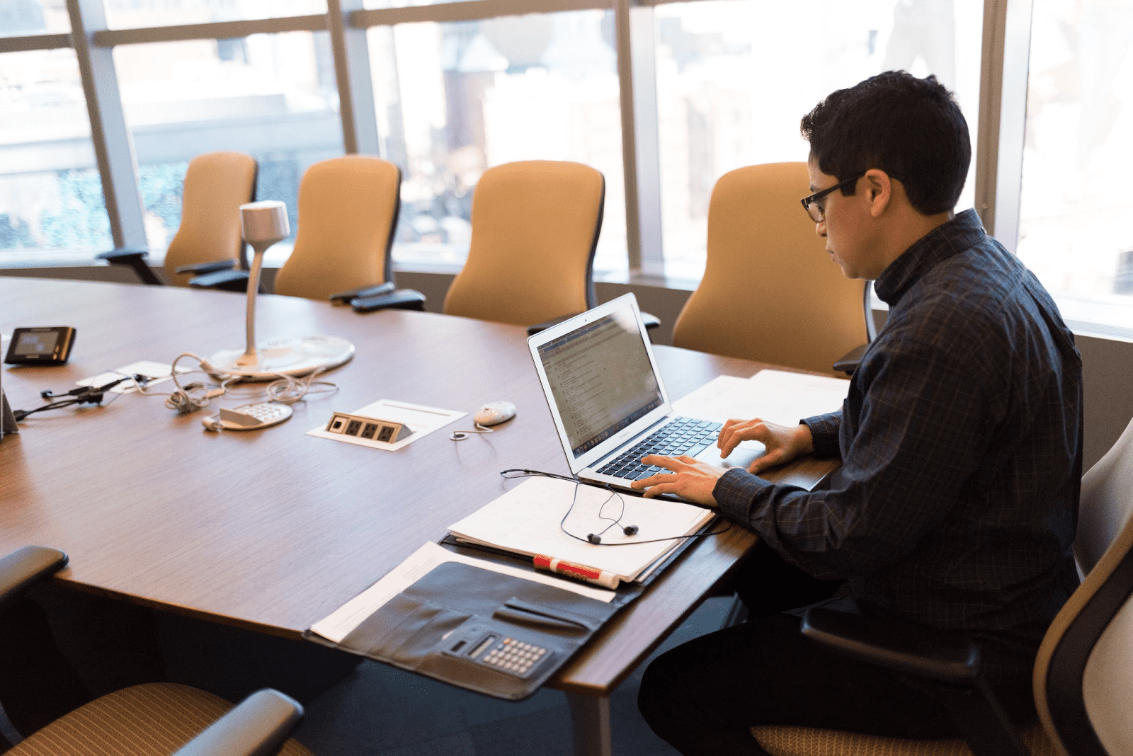 man preparing for virtual meeting in a conference room