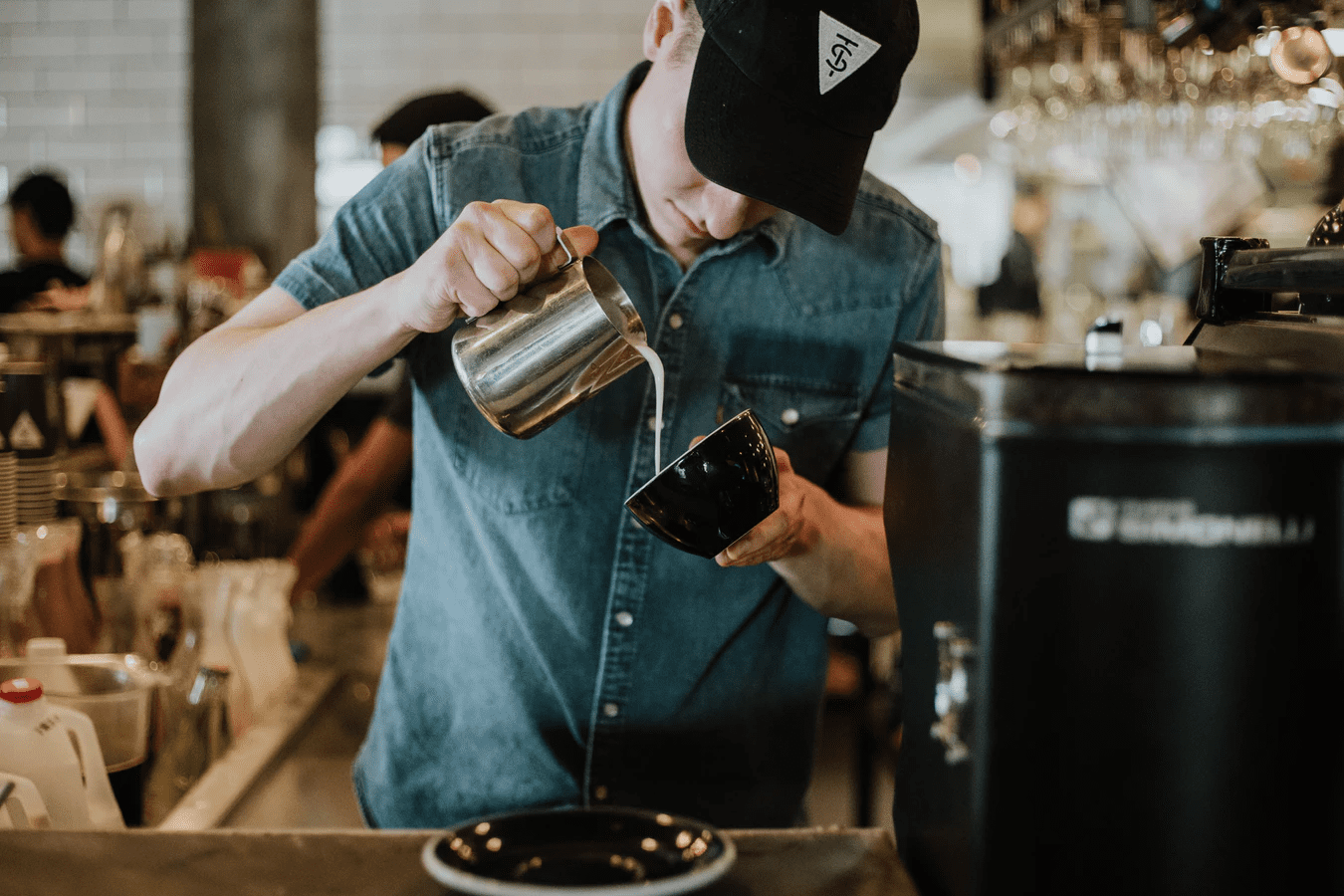 man dressed casually and working at a coffee shop