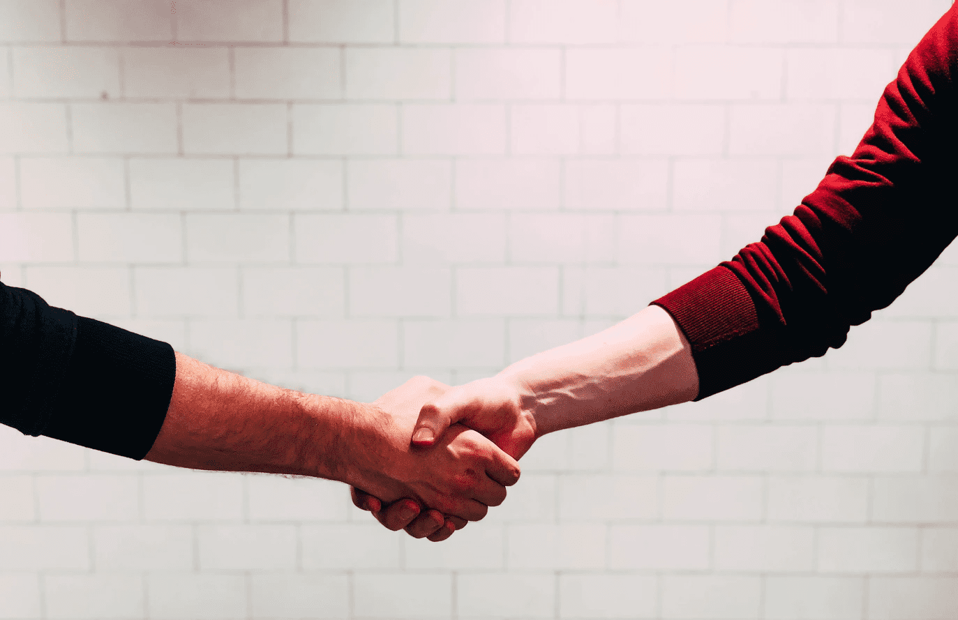 Coworkers shaking hands after a promotion announcement