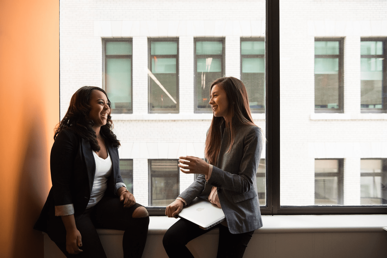 2 female managers discussing their company's code of conduct