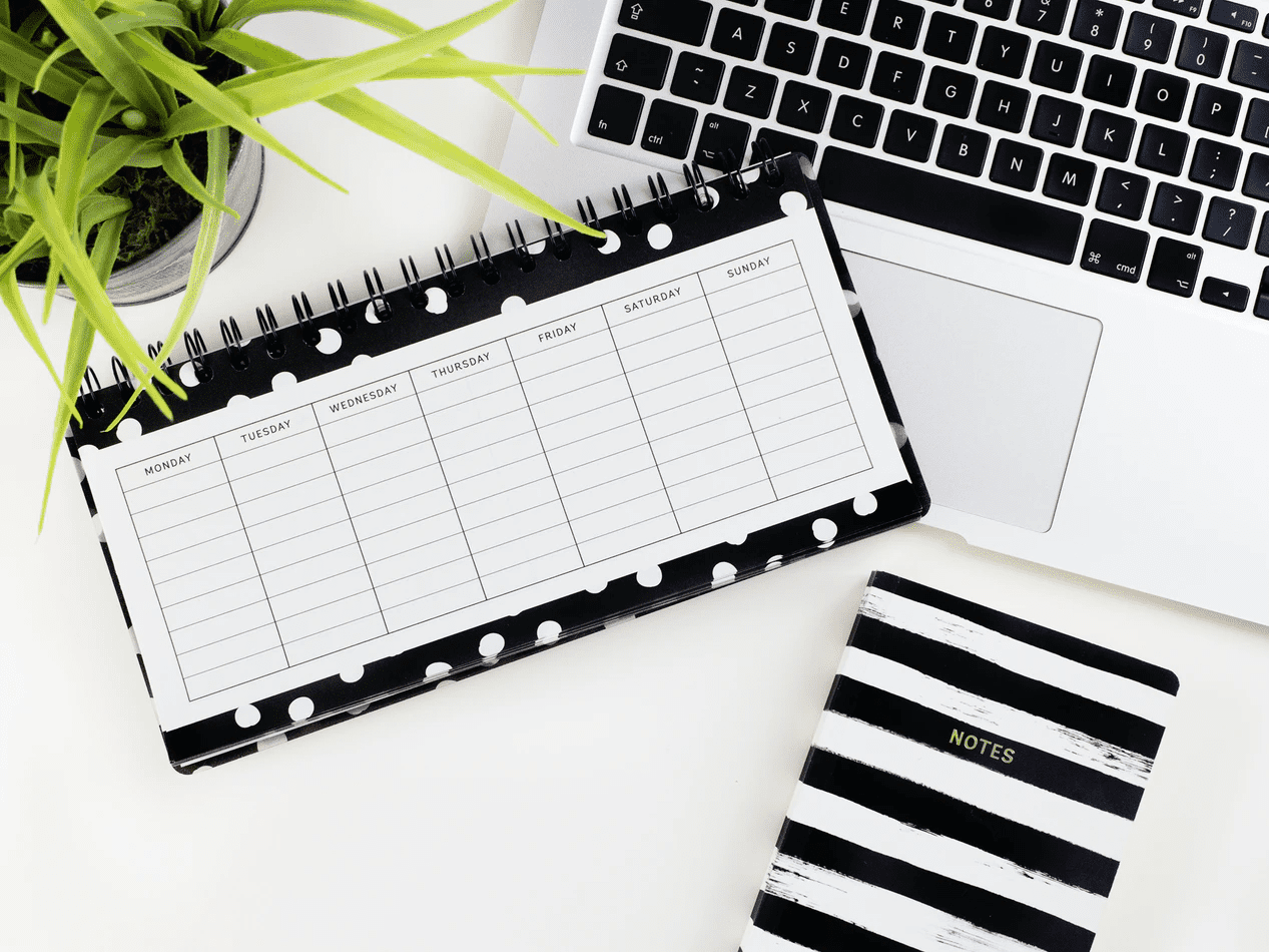 desk calendar on top of laptop