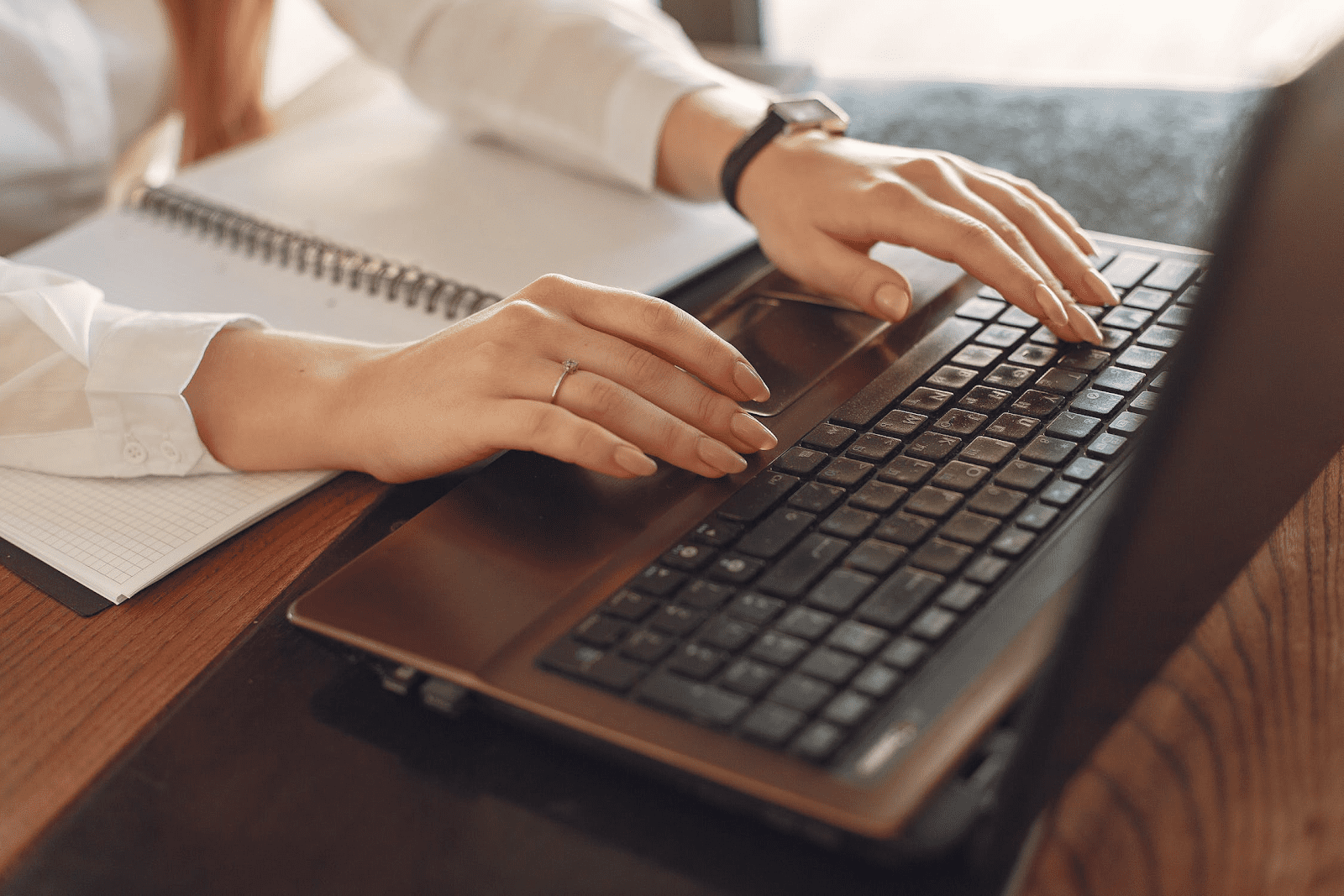 business owner writing a code of conduct on her laptop