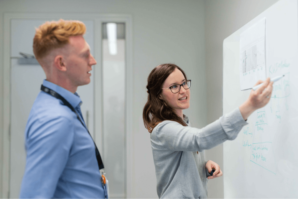 woman using an organizational chart with her coworker