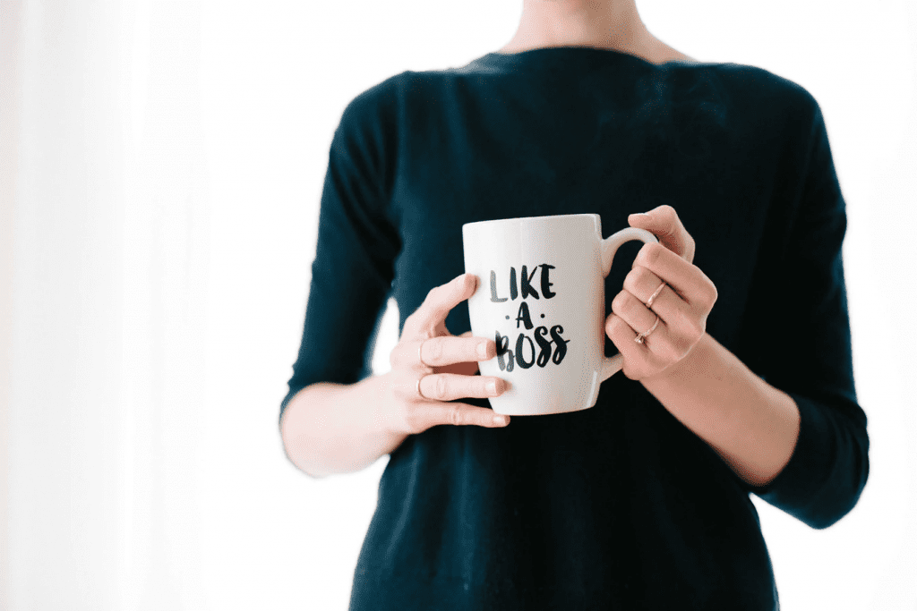 woman holding a mug and contemplating what is comp time