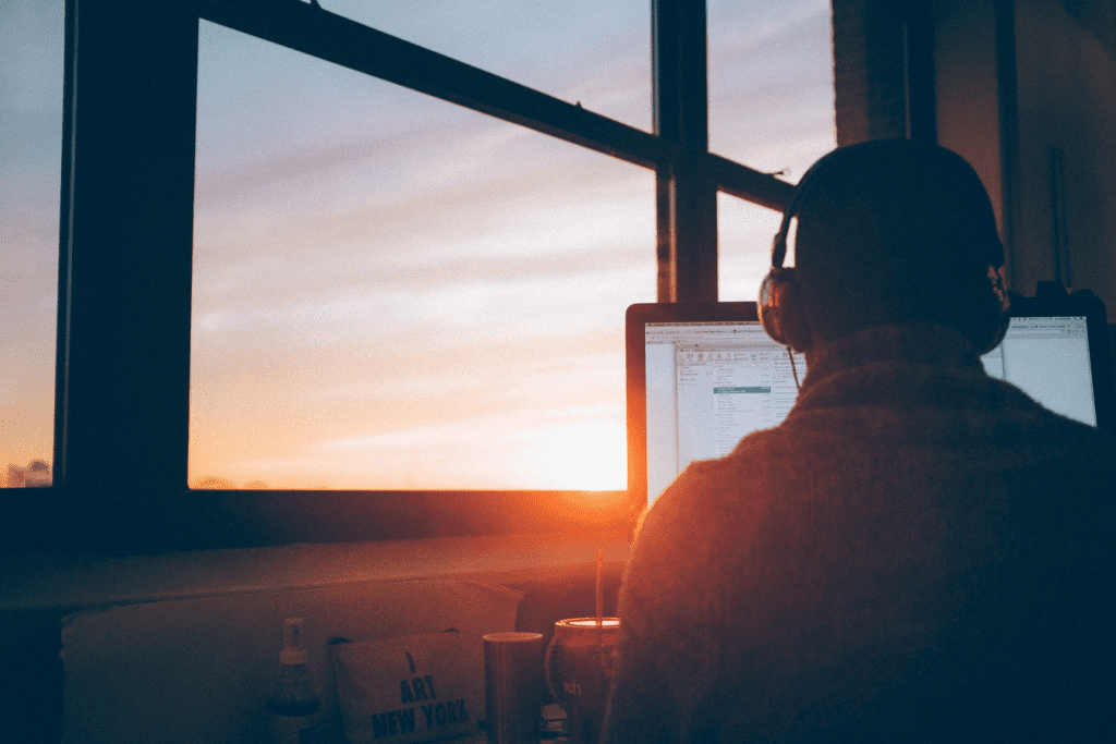 Employee wearing headphones while working on a computer