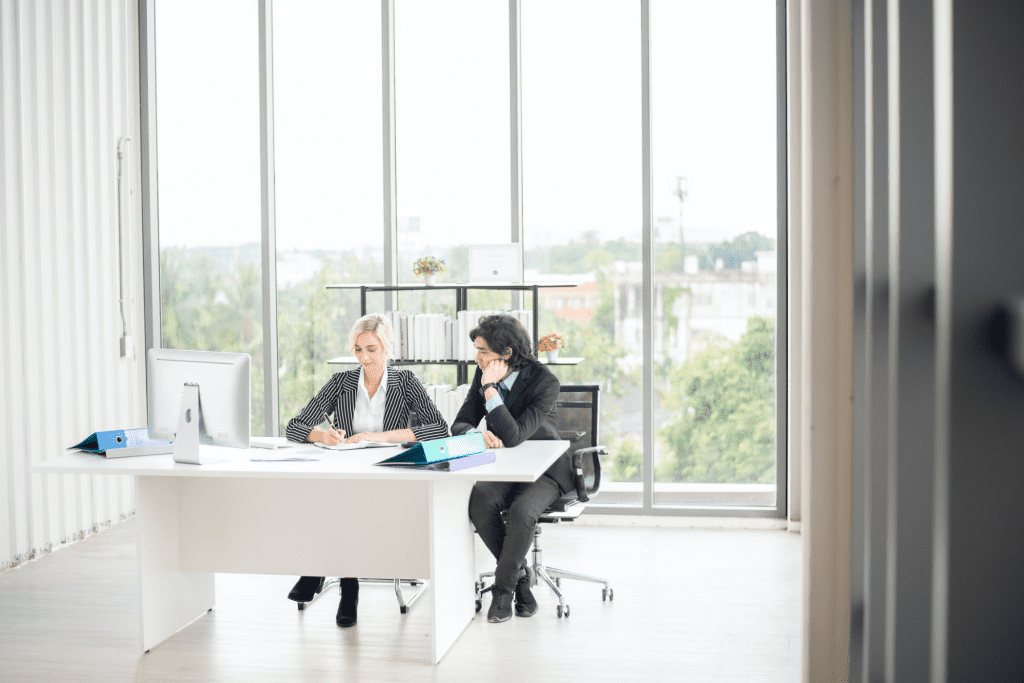 Two workers in an office discussing the gig economy 