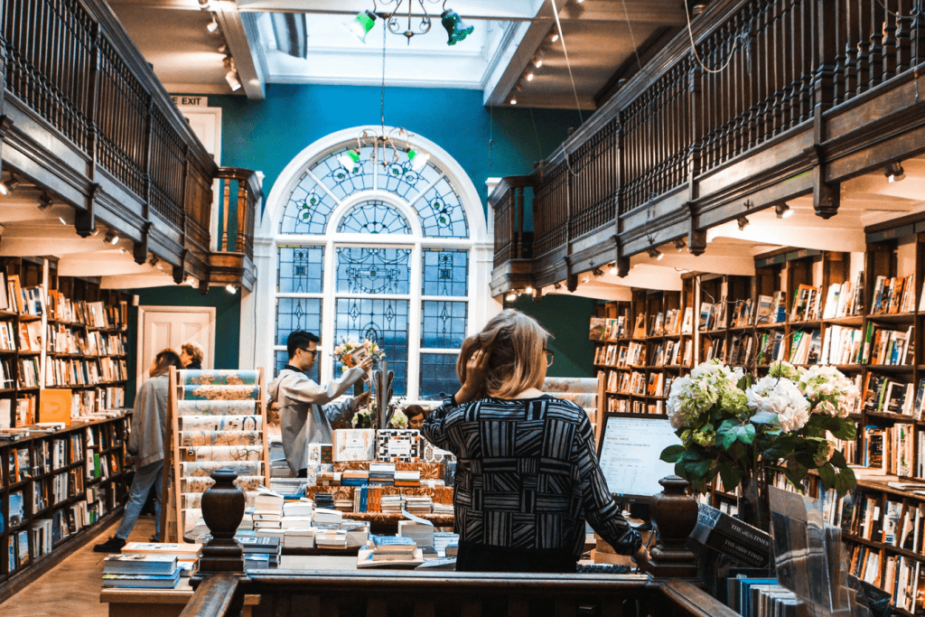 Inside library with woman at check out desk