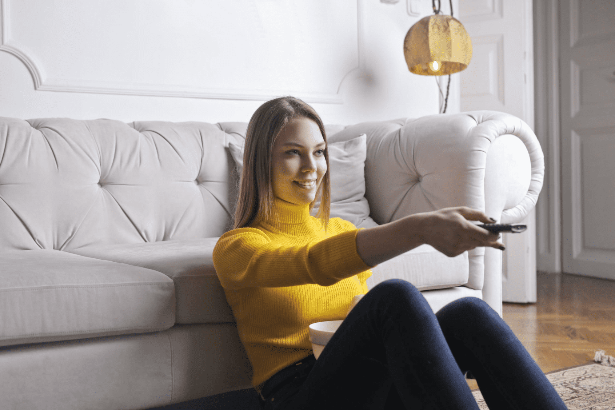 Woman sitting on the ground watching tv