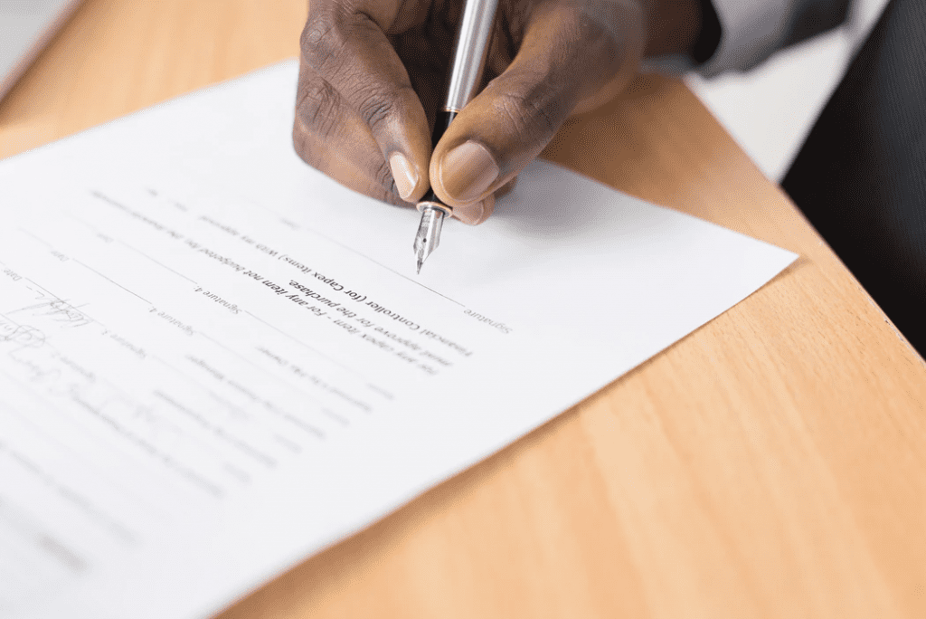 Person filling out employee application form