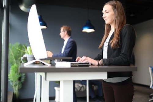 Employee working at a standup desk