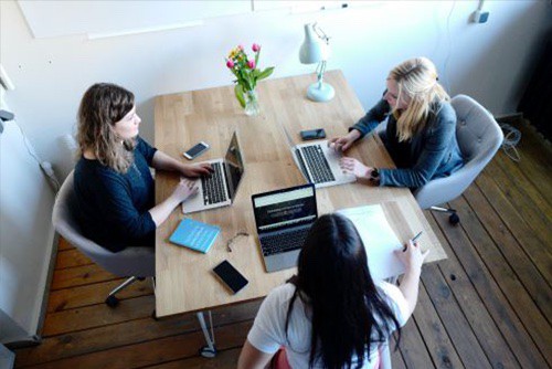 Three coworkers having a meeting on leadership theories