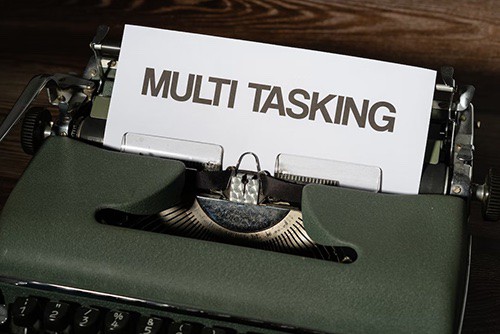 Typewriter with paper that says Muli Tasking
