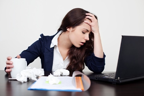 Woman who is feeling sick at work