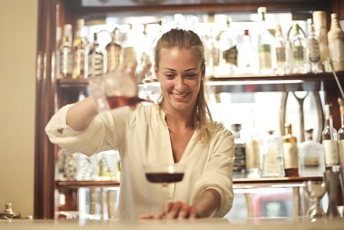 Woman making a cocktail