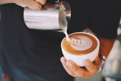 Barista pouring a cop of coffee