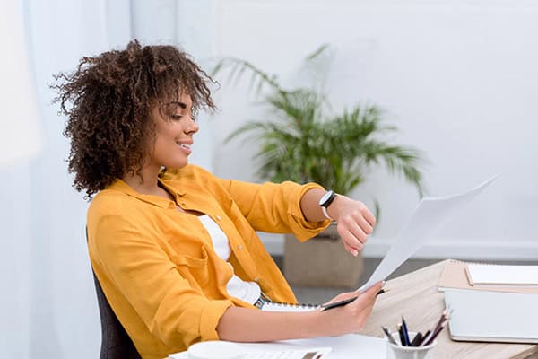 Woman checking watch for her clock in clock out time
