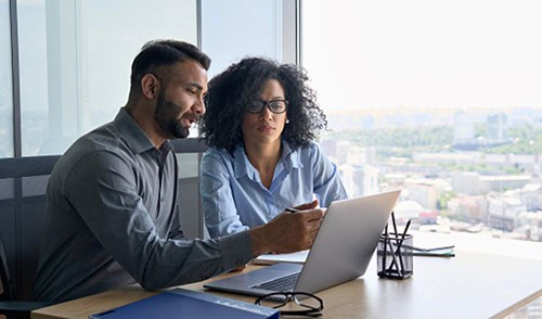 two employees discussing employee work scheduling
